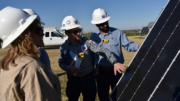 The team at maritimegasoil's Lost Hills facility check on the solar panels